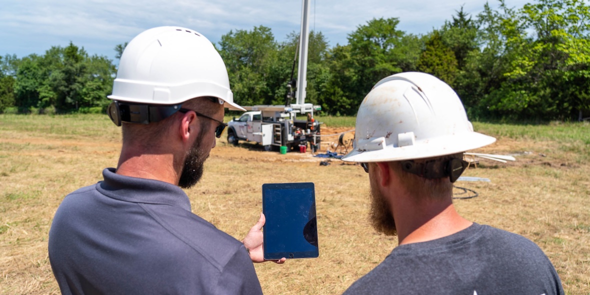 Justin Davis of the department’s Well Installation Section and a contractor with Flynn Drilling Company access well information from the WISDIM application while on site.