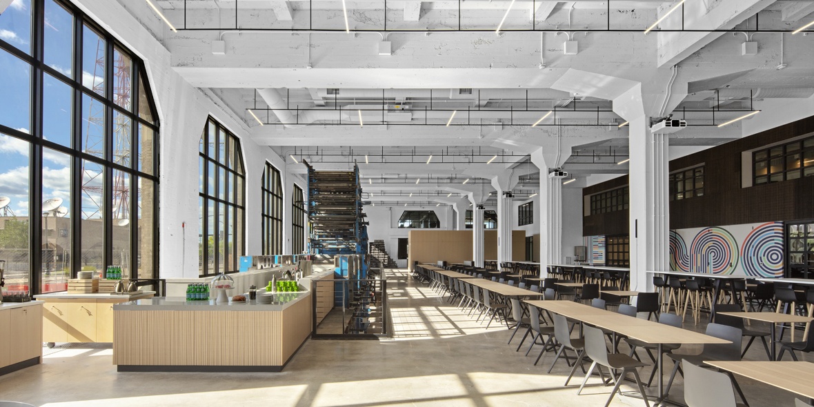 The building at 900 North Tucker Blvd. in St. Louis now features an expansive cafeteria and modern workspaces for employees of the current occupant, Square. The cafeteria retains the original printing presses as a nod to the building’s history.