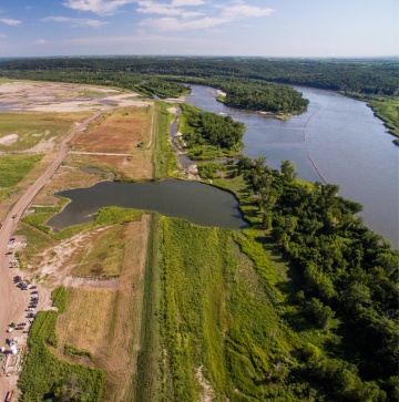 An aerial view of the river levee construction in Atchison County. The river is on the right, and a large pool of water in the middle of the levee shows where a previous breach occured.