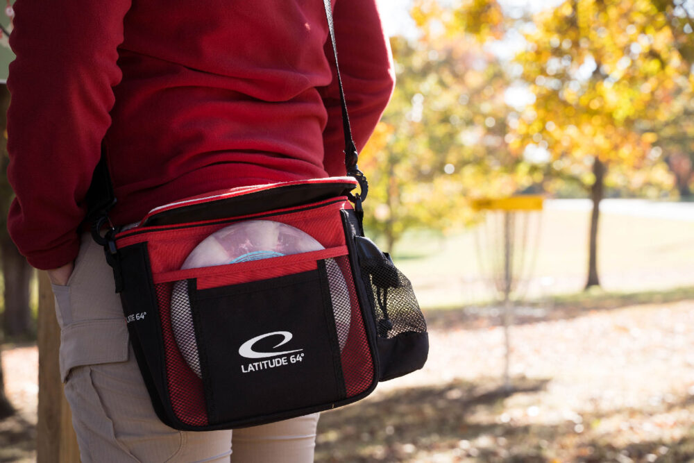 An image of a carrying bag with various discs stuffed into the pockets.