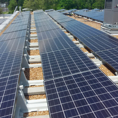 An image of solar panels on the roof of a building.