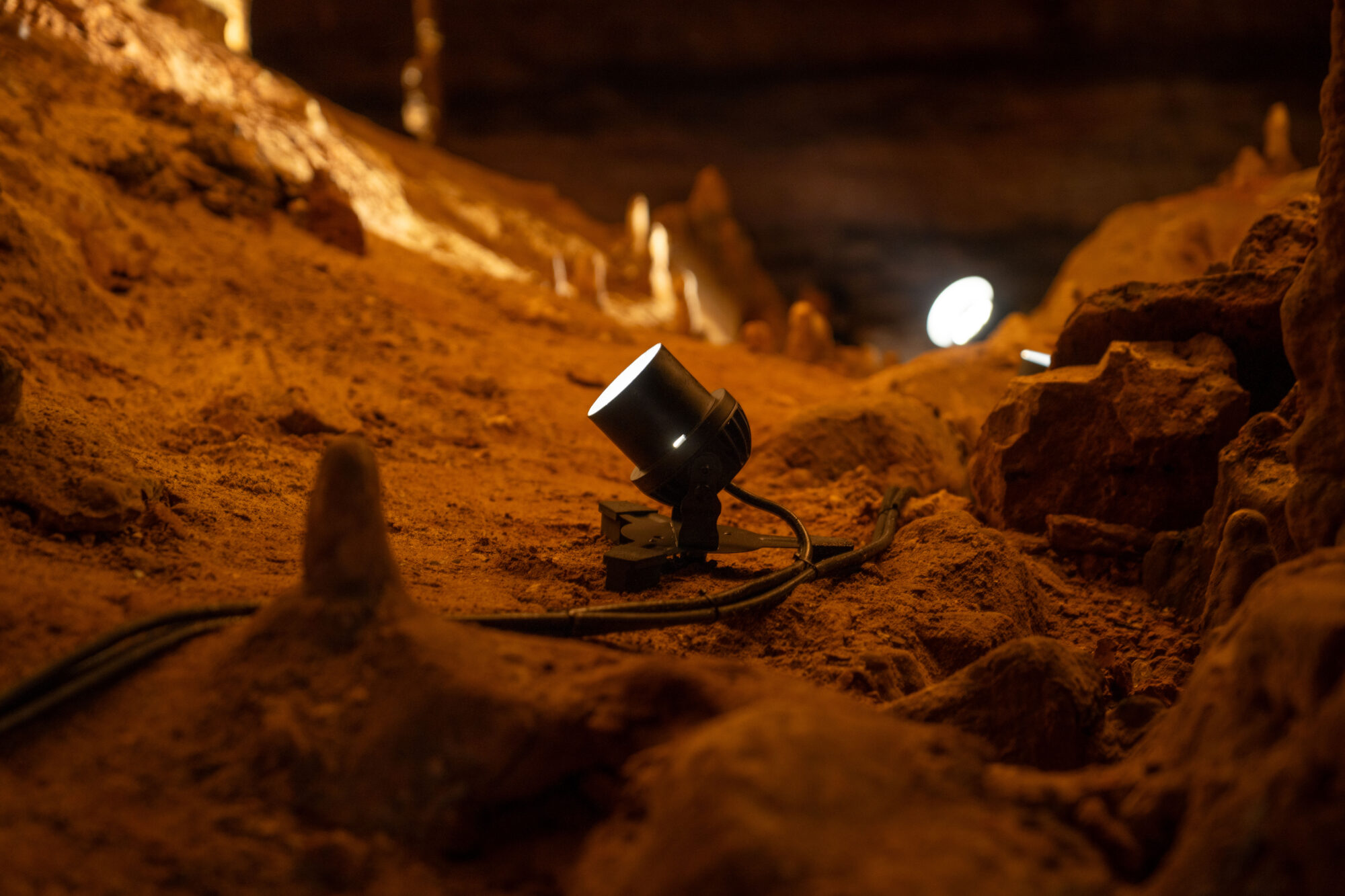 Photo of a light fixture in a cave.