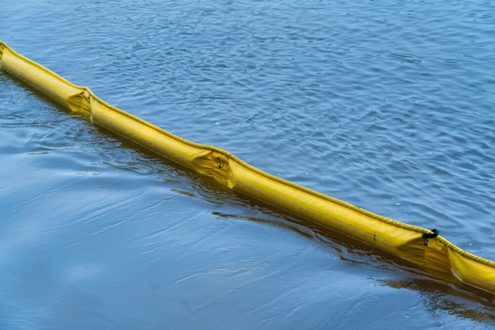 Photo of containment boom floating on water.