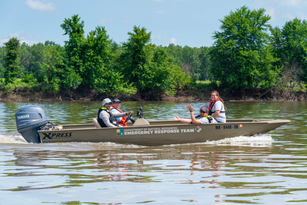 Photo of people in a motor boat on water.