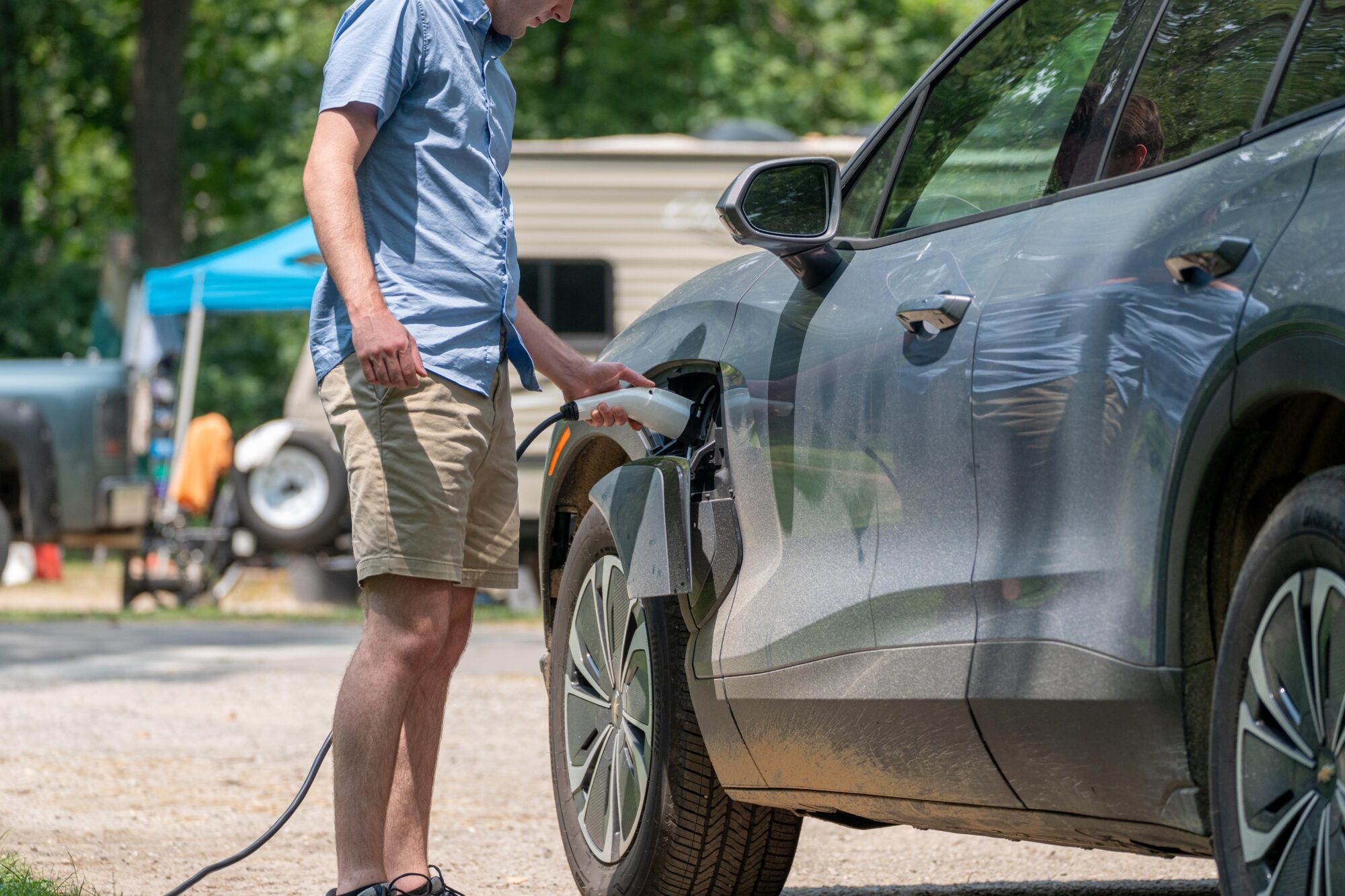 Photo of a person plugging in an electric vehicle.