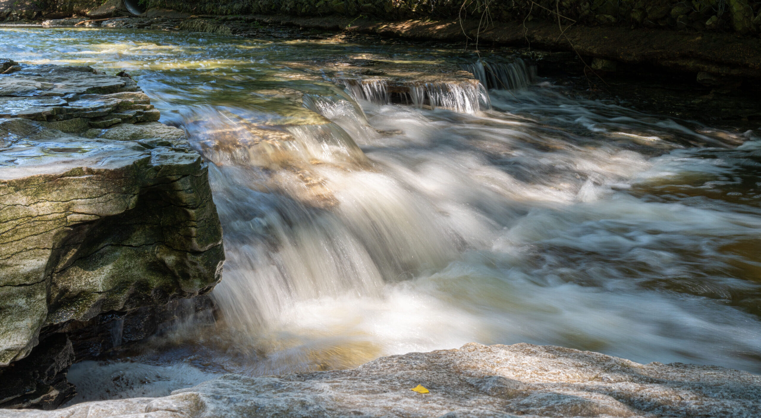 Photo of a small waterfall in a stream.