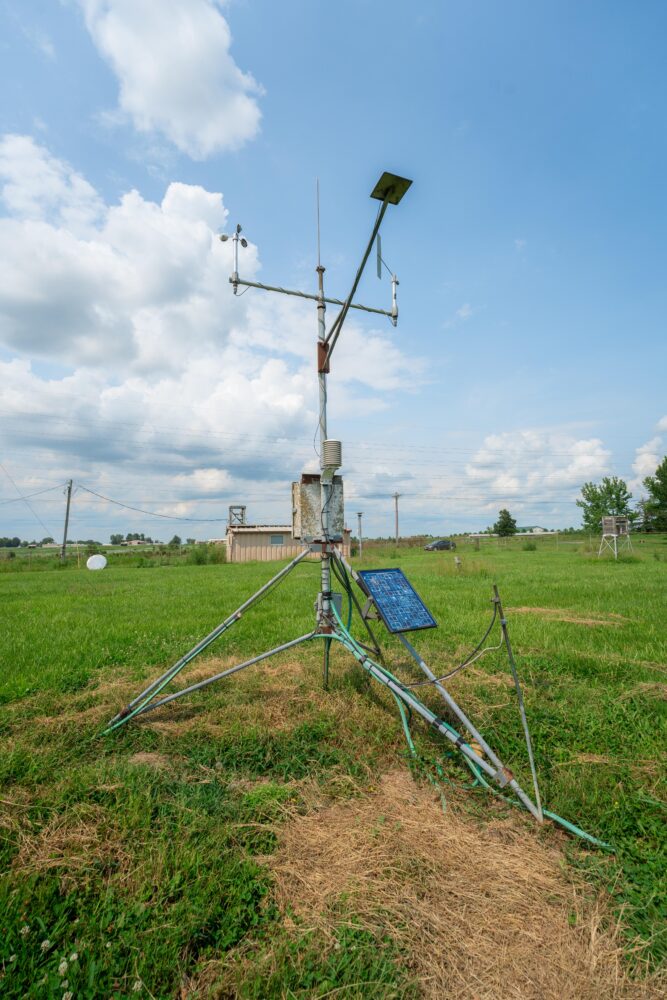 Photo of a weather station set up in a field.