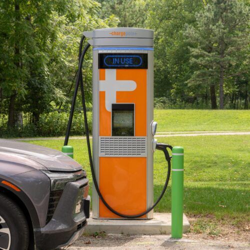 Photo of a vehicle being charged at a charging station.