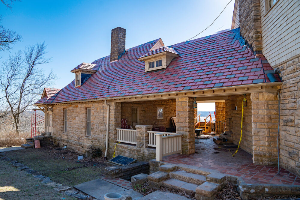 Stone home with a new roof made with clay shingles
