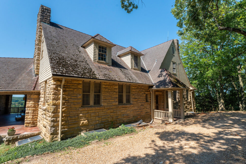 Stone home with a rotted moss covered roof