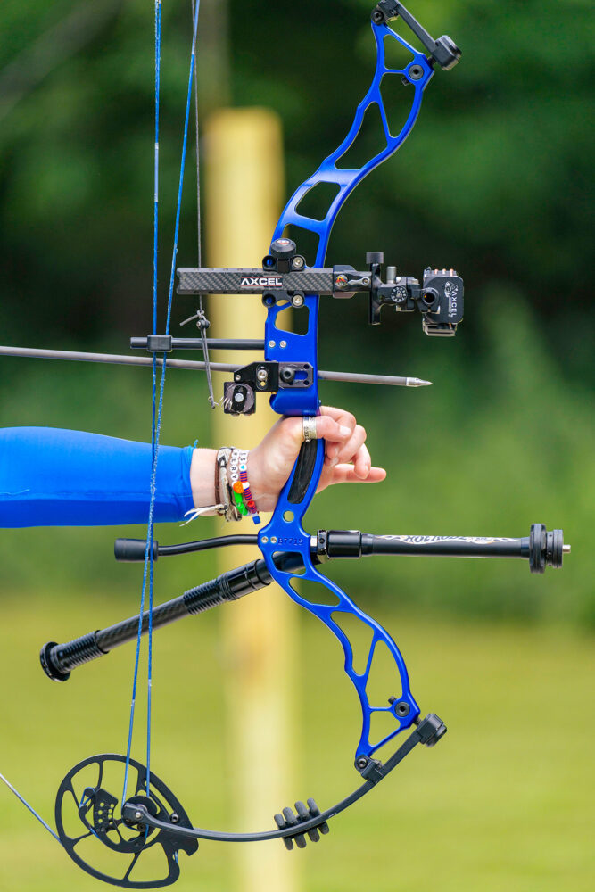 A person pulls back an arrow on a compound bow.