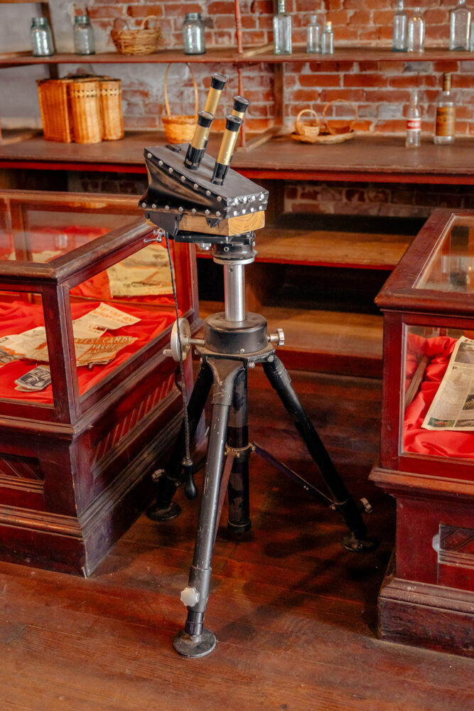 Old train whistle sits between two display cases.